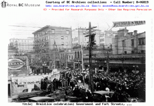 An Armistice celebration on Government Street and Fort Street. Permission to use this image must be obtained from the BC Archives.  Source: Image Courtesy of Royal BC Museum, BC Archives - Call Number: A-06819 See BC Archives Date: 11 Nov 1918
